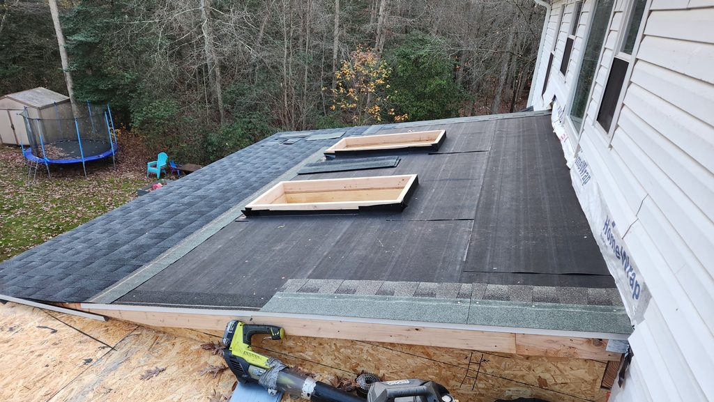 Tapered Roof Crickets Around HVAC Curbs on Philadelphia Flat Roofs shown in a realistic Philadelphia, PA residential construction setting.