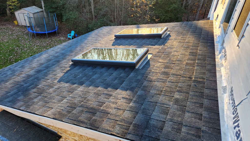Tapered Roof Crickets Around HVAC Curbs on Philadelphia Flat Roofs shown in a realistic Philadelphia, PA residential construction setting.